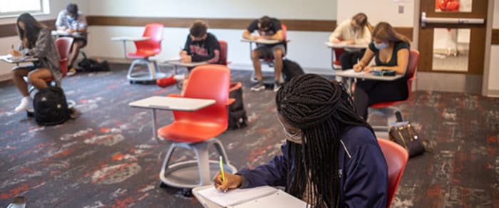 Students attend class at Indiana University with masks on and 6-feet apart.